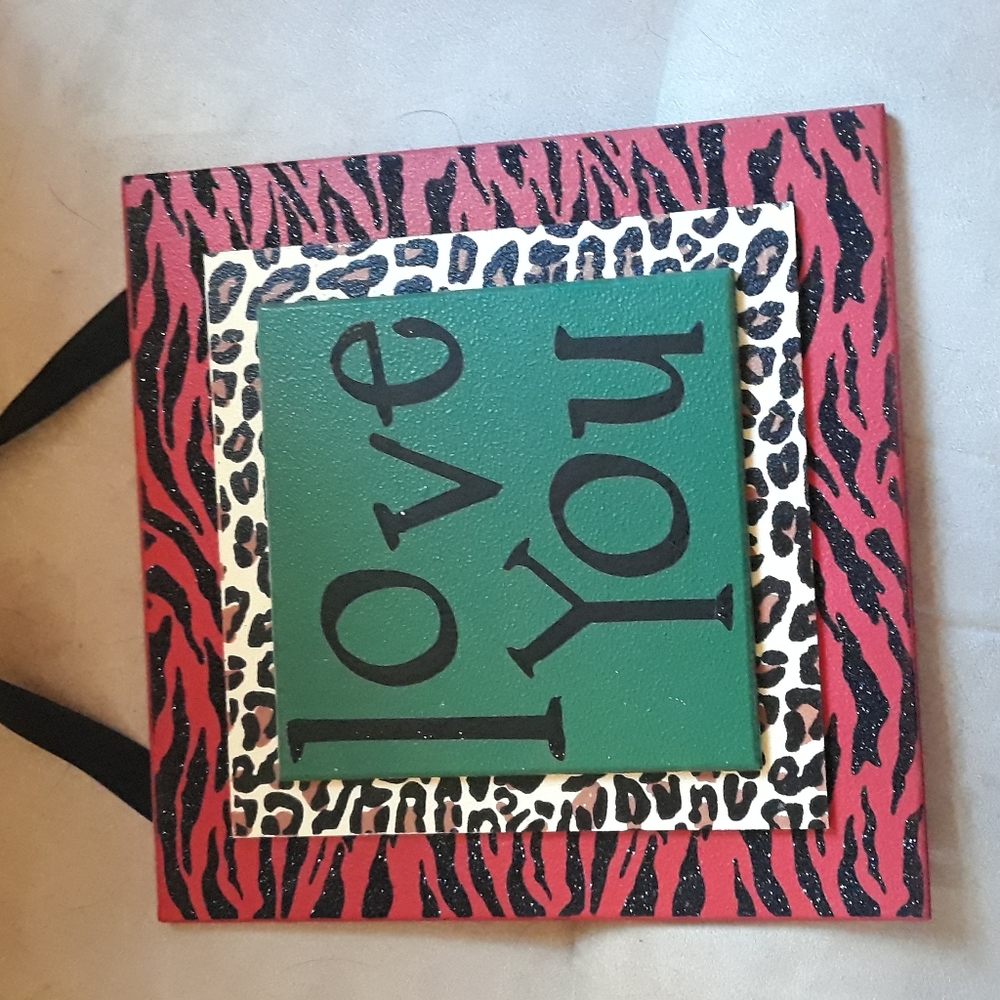 Sweet "love you" wall hanging sign. Fun colors & animal prints.